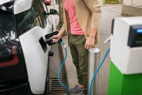Man charging electric car