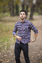 young handsome man in nature ,autumn .serious thoughts