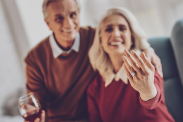 Expensive jewelry. Delighted mature woman feeling happiness while spending time with her husband