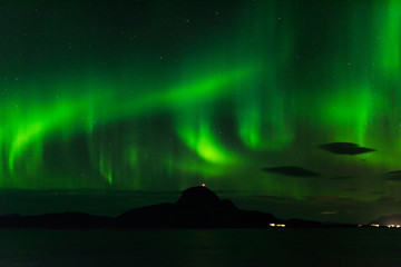 norwegian aurora borealis with mountains and water, view from hurtigruten ship boat, norway, europe, green northern lights