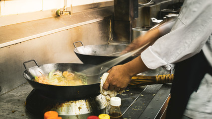 Chef stirring cooking