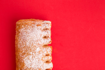 cream cane cake, with sugar in red background