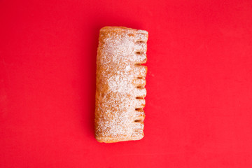 cream cane cake, with sugar in red background