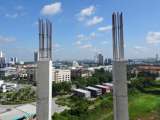 Reinforcement concrete column as part of building structure at the construction site. Reinforcement bar on top of column ready for next stage of construction.