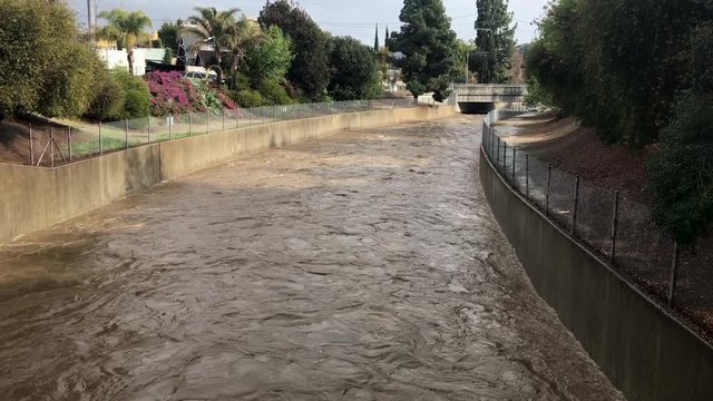 After a rainstorm, flood waters surge into the drainage system of the LA River.