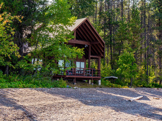 Fototapeta na wymiar A cabin that is nestled neatly into the forest offers the quiet, serene getaway.