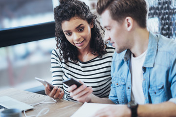 No way. Sincere two friends communicating while using phones