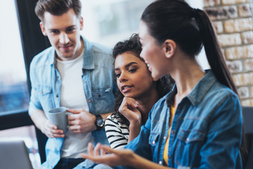 Valuable proposition. Appealing three students studying while talking