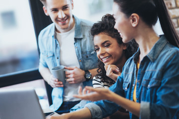 Task for three. Pleasant three students studying while debating