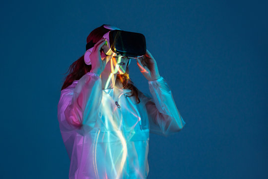 Woman touching air in VR glasses