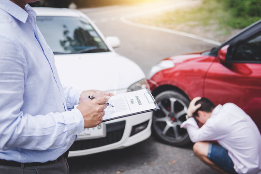 Traffic Accident and insurance concept, Insurance agent working on report form with car accident claim process