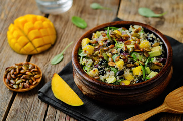 Mango black bean arugula pumpkin seed quinoa salad