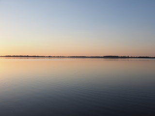 Symmetrical panorama of sun set over artificial european Goczalkowice Reservoir in Poland, beauty blue sky on landscape
