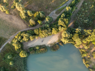 Aerial view of a pond, field and road