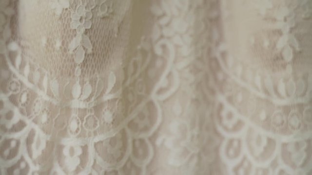 Vintage wedding dress hanging in the forest.