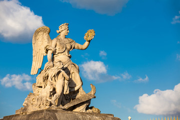 Angel statue at the entrance of the Versailles Palace in a freezing winter day just before spring