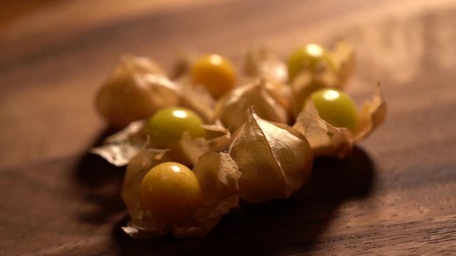 Closeup of husk cherries in and out of their husks rotating.