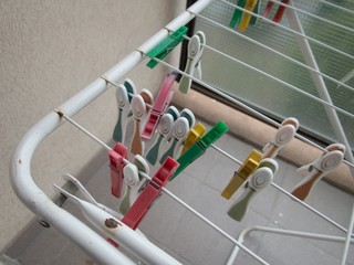 clothes pegs on a white line dryer