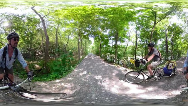 4K 360 vr of elderly man and mature man pulling a trailer with a dog at C&O Canal National Park.