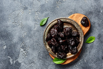 Dried prunes on plate. Top view of peeled plums. Top view.