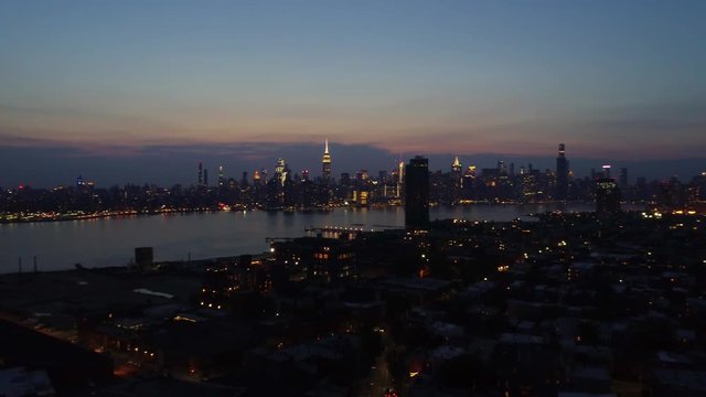 Beautiful night time view of Brooklyn, NY flying over city