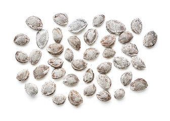 Salted apricot seeds isolated on white background. Apricot bones fried with salt in ashes. Top view. Flat lay