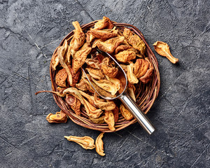 Dried pear, apple on black table. Top view.