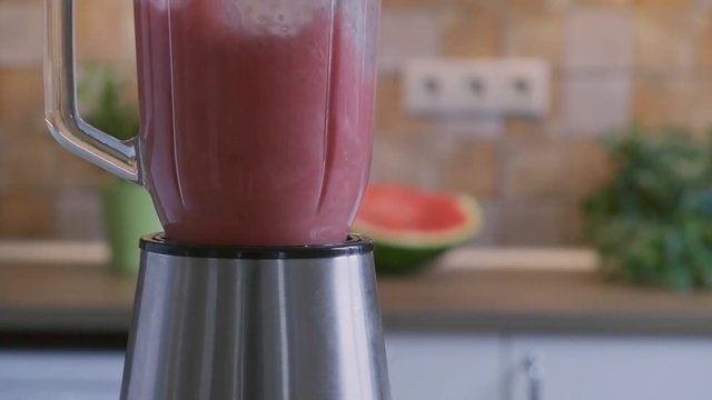 Working blender with red cocktail, slow motion vido