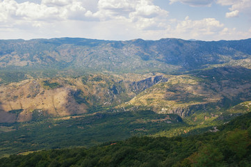 Fototapeta premium Mountain summer landscape. Montenegro, Dinaric Alps, view of Bjelopavlici plain near Ostrog monastery