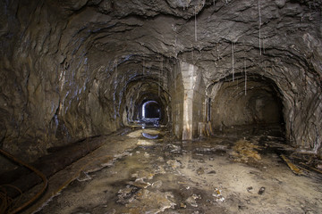 Naklejka premium Underground abandoned gold iron ore mine shaft tunnel gallery passage with timbering wooden