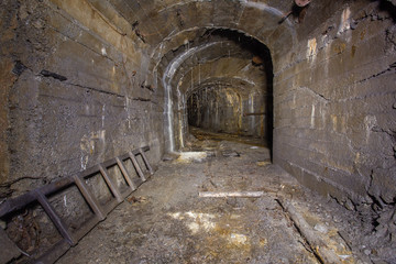 Underground abandoned gold iron ore mine shaft tunnel gallery passage with timbering wooden