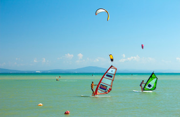 Windsurf and kite surfing action scene in blue sea background