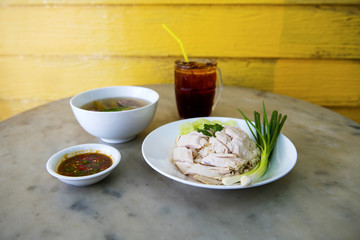 Boiled chicken, fillet on a plate with a slice of cucumber to eat a meal with rice and sauce, Fast Food commonly eaten in the countries of Thailand