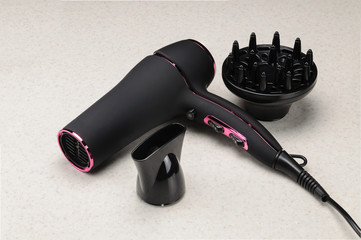 Grey mat hair dryer on the marble background with accessory