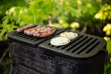 Brats and onions grilling