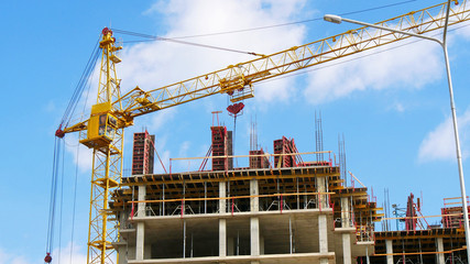 Fototapeta na wymiar Hoisting crane and building activity.Construction site. Construction of the new building.