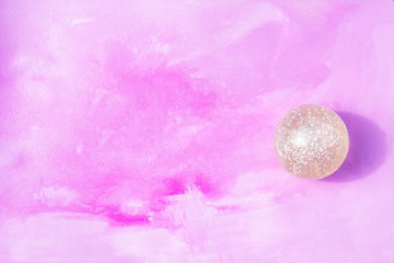 ball with sparkles on a pink background