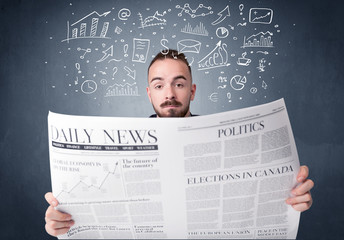 Young smart businessman reading daily newspaper with business plan graphics above his head