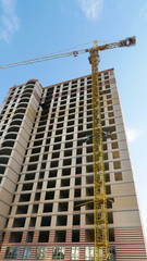 Fototapeta na wymiar Crane and building under construction. Skyscraper construction. Construction site.