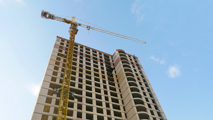 Fototapeta na wymiar Crane and skyscraper under construction. Construction site.