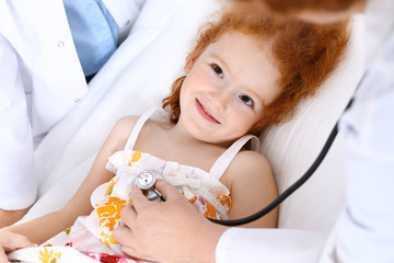 Doctor examining a little girl with stethoscope.Medicine and healthcare concept