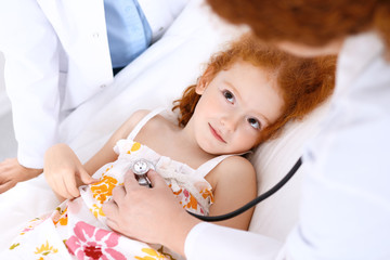 Obraz na płótnie Canvas Doctor examining a little girl with stethoscope.Medicine and healthcare concept