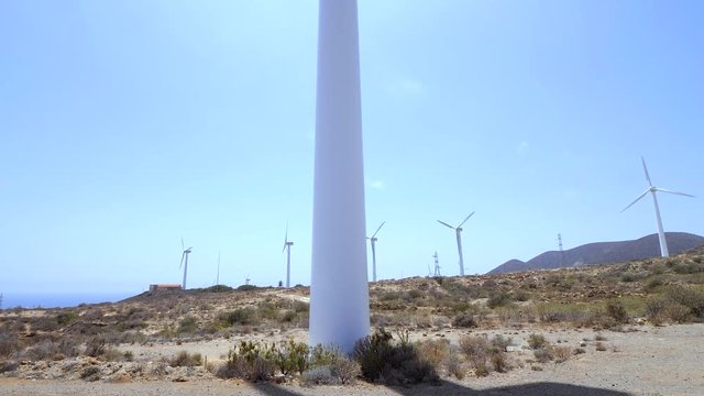 From the shadow of the turbine blades to the top of a windmill. Recorded at a field of Renewable Energies in the isle of Tenerife, Canary Islands (ES)