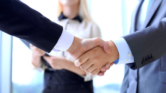 Business people shaking hands as a sign of agreement. Success concept