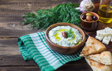 Tzatziki sauce in wooden bowl