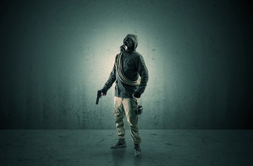 Bad agent in a dark room with arms on his hand and gas mask
