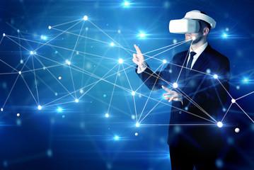 Businessman in virtual reality goggles investigate global network connectivity concept
