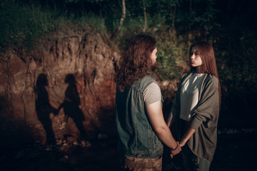 Young adult pair. Man and woman holding hands.