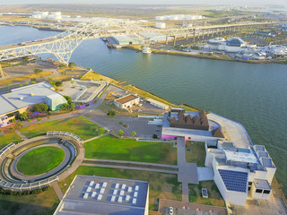 Aerial view Harbor Bridge and Water Gardens from Bayfront Science Park in Corpus Christi, Texas, USA. Row of white oil tanks in distance, cityscape, industrial and transportation background