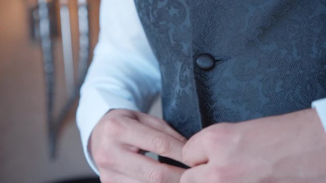 a man who bucks buttons on his suit